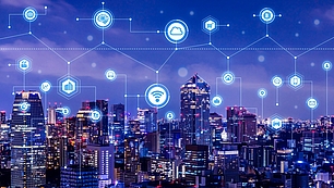 Connected city skyline with network icons representing 5G New Radio and mobile connectivity