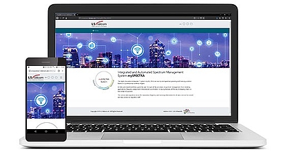 Responsives Spektrummanagement-System auf Laptop und Smartphone Ein Laptop und ein Smartphone zeigen die LS telcom-Website mit einem integrierten und automatisierten Spektrummanagement-System vor einer Stadtsilhouette mit Netzwerksymbolen.