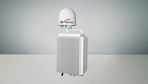 Eine kompakte weiße Signalüberwachungseinheit mit einem gerippten Kühlkörperdesign und einer kuppelförmigen Antenne mit der Aufschrift 'LS telcom' oben. Unter der Antenne befinden sich Anschlussports für Signal-Ein- und Ausgänge.