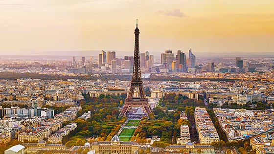The Eiffel Tower and surrounding cityscape during sunset in Paris. Title: Iconic Eiffel Tower at sunset.